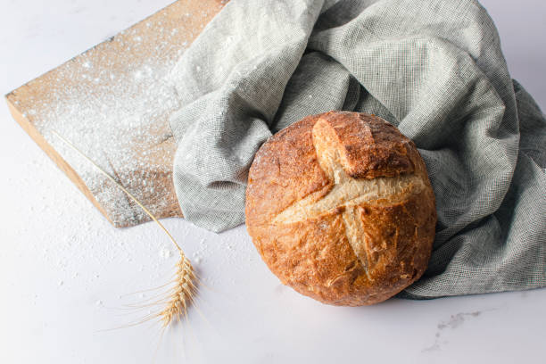 istock Freshly baked round bread with a crispy brown crust. 1864295908