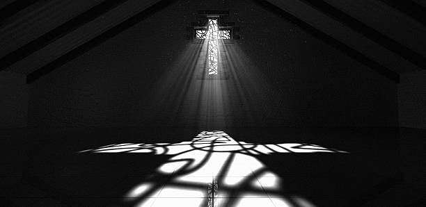 Stained Glass Window Crucifix Black And White An interior building with a crucifix shaped stained glass window with a spotlight rays penetrating through it reflecting the image on the floor stained glass photos stock pictures, royalty-free photos & images