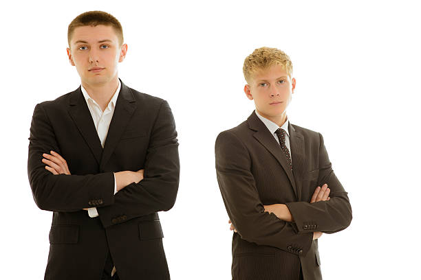 istock group of two businesspersons standing seriosly 186432983