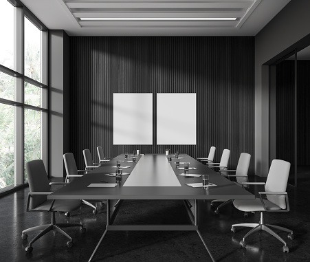 Dark wooden business meeting room interior with board, chairs in row on black concrete floor. Conference workplace with panoramic window. Two mock up canvas posters. 3D rendering