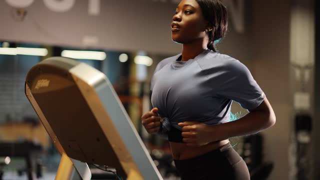 Woman running on treadmill in the gym