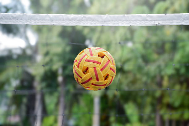 Sepak takraw ball on net, soft and selective focus on ball, outdoor sepak takraw playing after school and after work concept.
