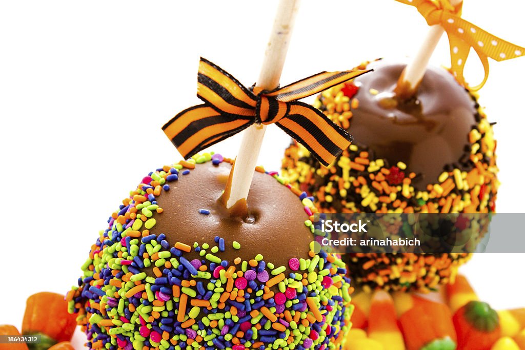 Caramel apple Hand dipped caramel apple covered with multi color sprinkles. Apple - Fruit Stock Photo