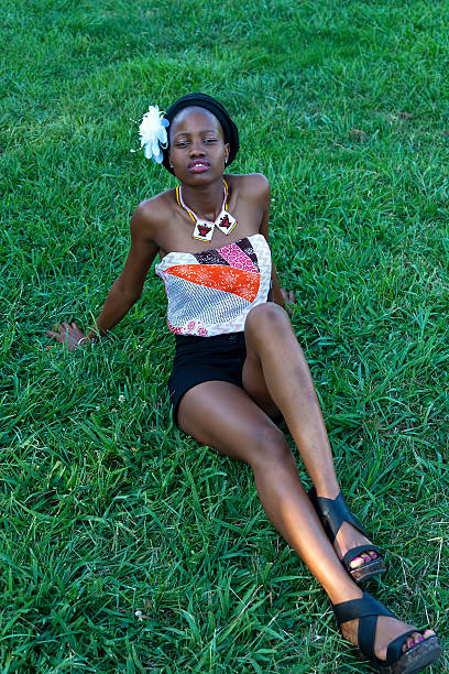 istock Young Black Woman Sitting on Grass Park 186434785