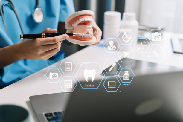 istock Doctor stomatologist is working on a Tablet computer and tooth model in a modern office in the morning at the desk. 1864356237
