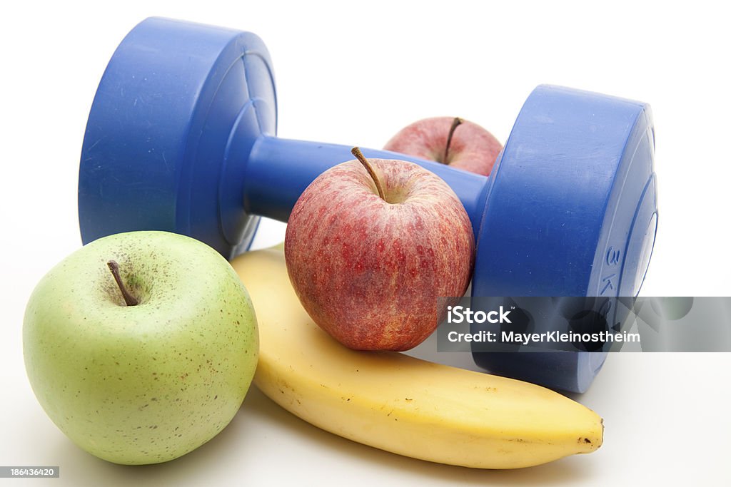 Apples and banana with dumbbell Apples and banana with dumbbell on white background Apple - Fruit Stock Photo