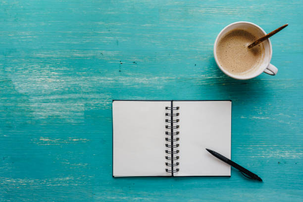 istock A cup of coffee and a blank notebook 1864365808