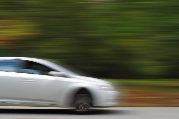 istock White Car in Blurred Motion on a Country Road 186436989