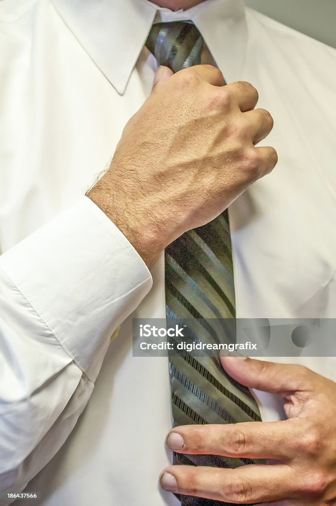 man fixing a tie with hands man fixing a tie with hands in white shirt Adult Stock Photo