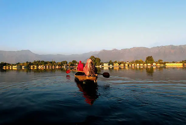 Two Muslim women returning home in evening after collecting lotus leafs, which they use to feed cattle and sometime they use to sell it cattle's owner. This is part of daily life of majority of women in Srinagar, Jammu and Kashmir, India.