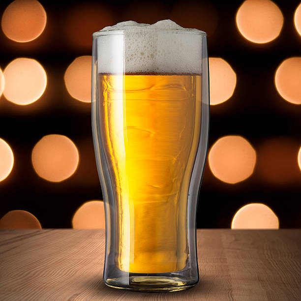 istock Glass of cold beer on wood table 186438229