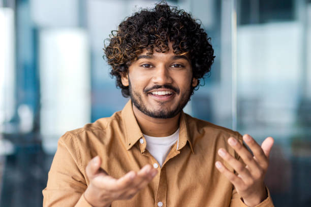 istock Webcam view, online video call, man smiling talking and gesturing looking at camera satisfied, businessman inside office at workplace, talking with colleagues 1864417951