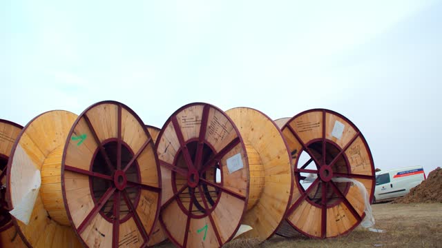 Lots of massive spools of cable at a construction site, electricity, 4k