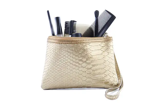gold colored makeup bag filled with make-up