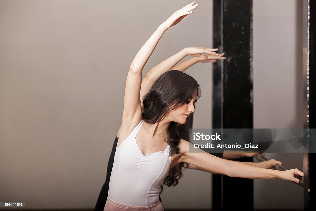 Practicing in a ballet barre Beautiful women practicing ballet in a barre at a dance academy 20-29 Years Stock Photo