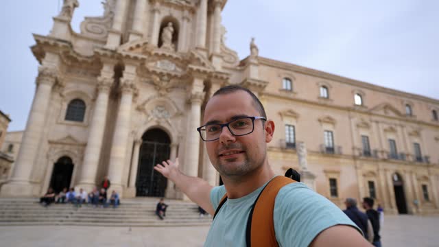 Male Tourist Taking Selfies In Front Of The Cathedral Of Syracuse On Ortygia Island