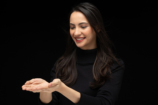 Photo of beautiful amazed girl wearing casual black t-shirt isolated black background