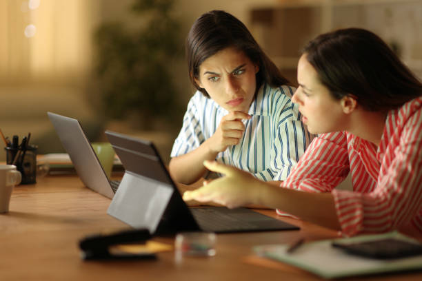 istock Suspicious tele workers working online at home 1864461293