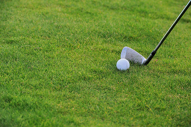 istock golf ball and stick on field close up 186447927