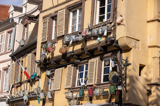 old half-timbered house with watering cans in Colmar, France in summer
