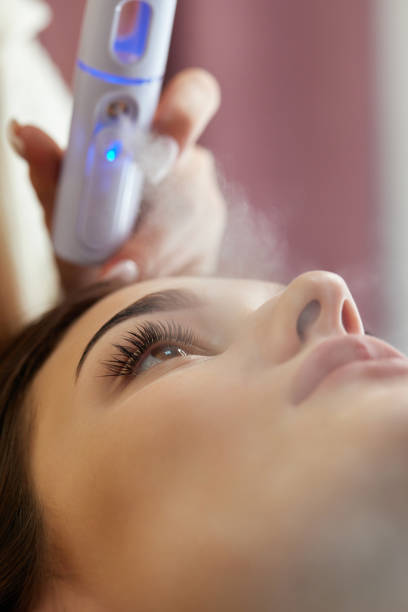 istock cosmetologist using primer spray for eyelash extension procedure 1864523147