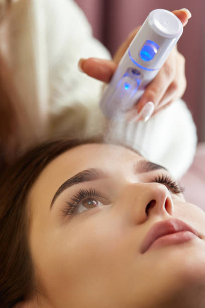 istock cosmetologist using primer spray for eyelash extension procedure 1864523167