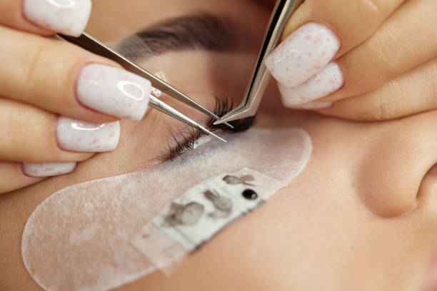 istock beautiful female face during lash extension procedure 1864523696
