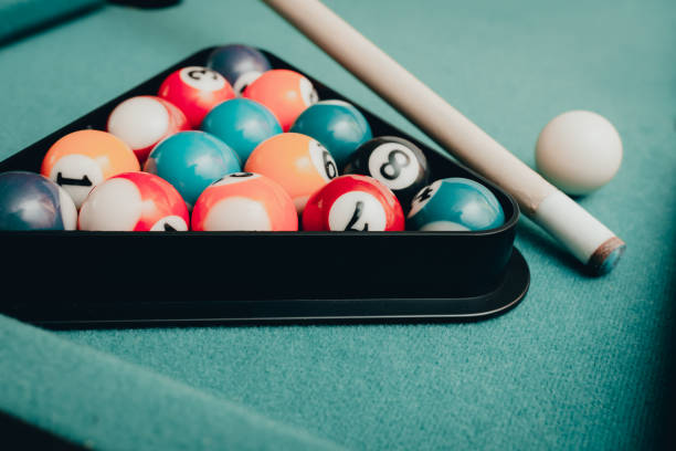 istock Multi colored billiard balls in the form of a triangle with numbers,a cue ball and a triangle on a pool table. billiard balls closeup.Toned. 1864525902