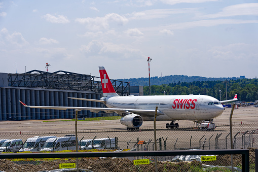 Parked Swiss airplane Airbus A330-343 registration HB-JHI at Zürich Kloten Airpot on a sunny summer day. Photo taken July 25th, 2023, Zurich, Switzerland.
