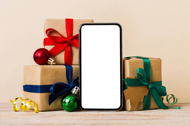 istock Digital phone mock up with rustic Christmas decorations for app presentation with empty space for you design. Christmas online shopping concept. Tablet with copy space on colored background 1864549759