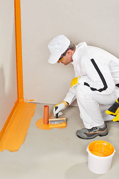 istock worker waterproofing around the wall, floor and siphon 186455561
