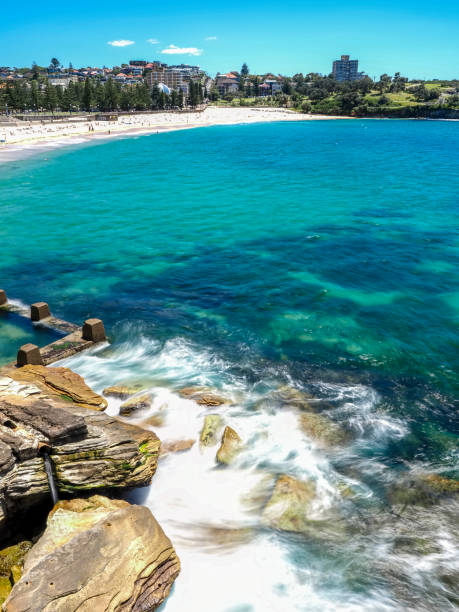 istock Powerful white waves crashing into coastline rocks 1864556694