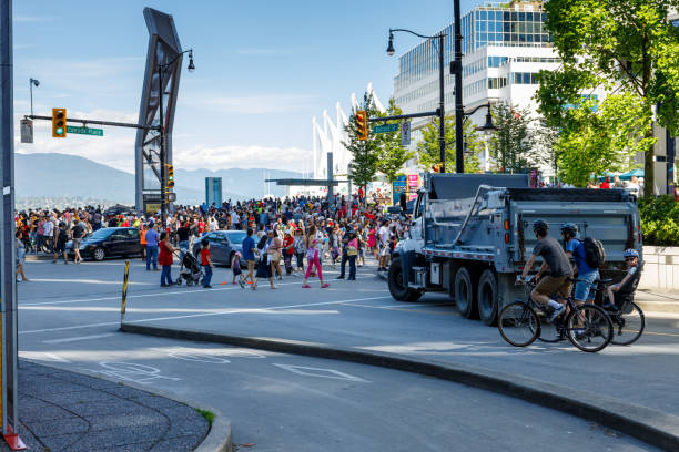 vancouver, canada - july 1,2023: crowds of people celebrating canada day in front of canada place in downtown vancouver - 12023 imagens e fotografias de stock