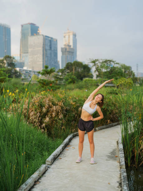istock Woman stretching before running in the park 1864568822