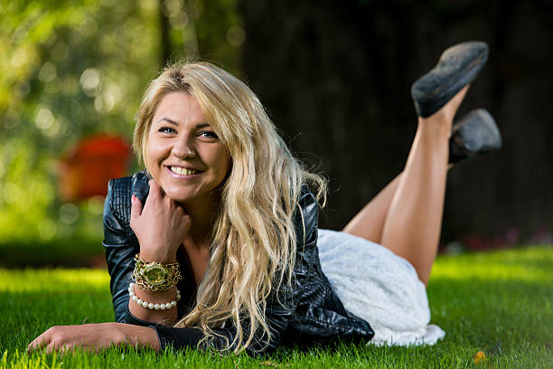 Beautiful Girl Lying Down On Grass