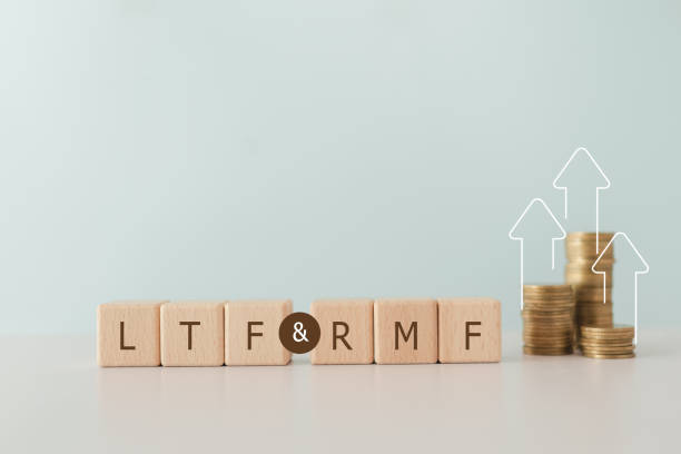 istock LTF, Long  Term Equity Fund, and RMF, Retirement Mutual Fund on wooden cube block with blurred stack of coin for  business financial, saving money, retirement concept. 1864582898