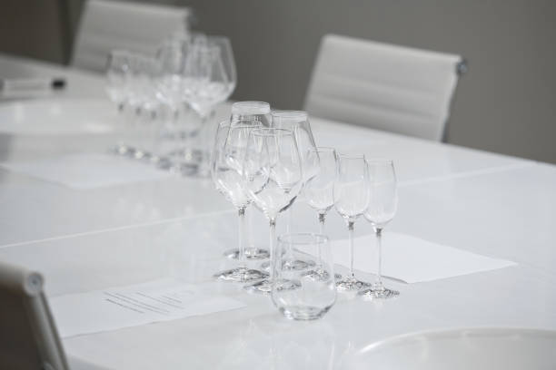 istock Empty wine glasses on table over white background. Service and restaurants, serving dishes. 1864592875