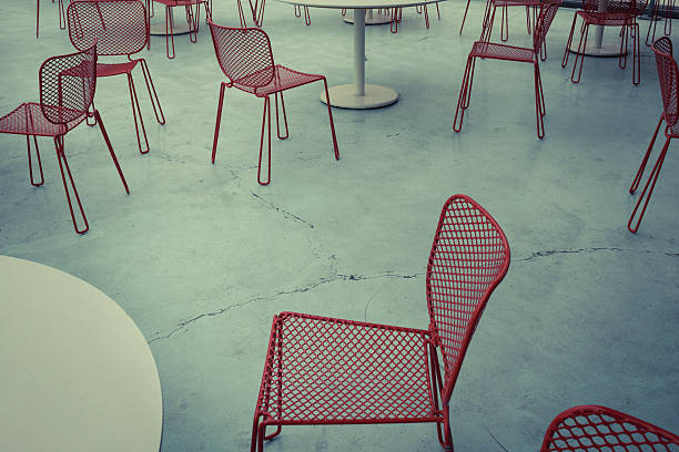 istock Red metal chairs on concrete floor 186460731