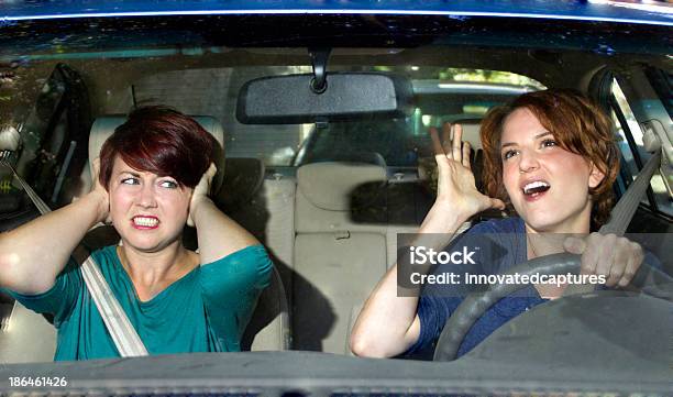 Driver Singing In The Car And Annoying A Passenger Stock Photo - Download Image Now - Singing, Car, Passenger