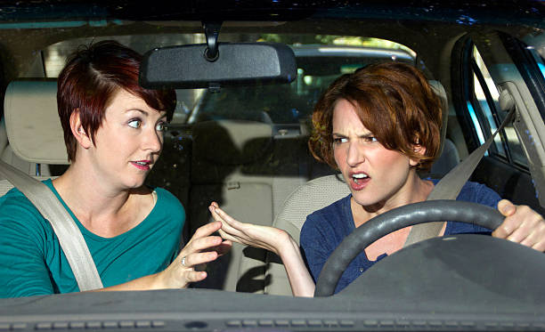 istock Backseat Driver Passenger Annoying a Female Driver in the Car 186461437