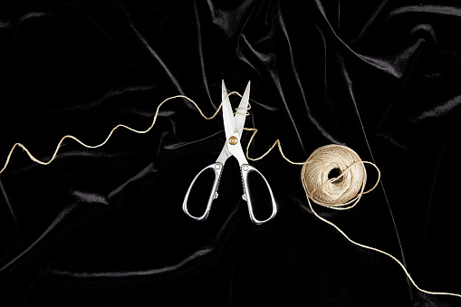 Top View Of Scissors And String On Black Velvet