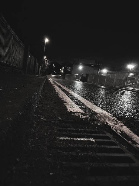 istock An empty wet road illuminated by street lights 1864625764
