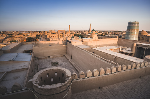 Panorama of the ancient city of Khiva in Khorezm in the evening at sunset with historical monuments and buildings