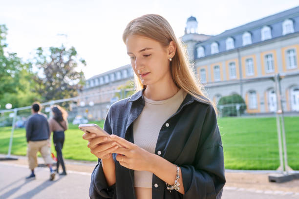 istock Young teenage female student using smartphone, outdoor 1864636785