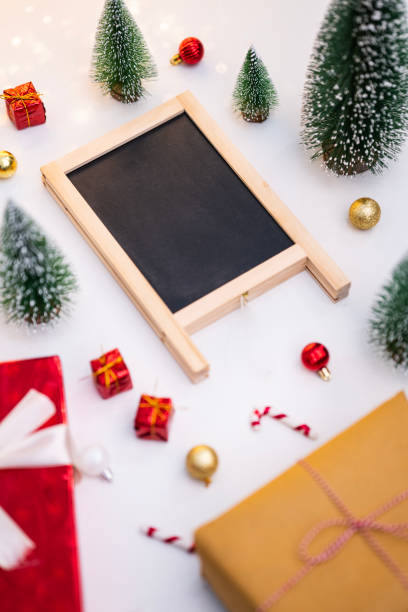 istock Christmas holiday decorations with empty black board 1864642758