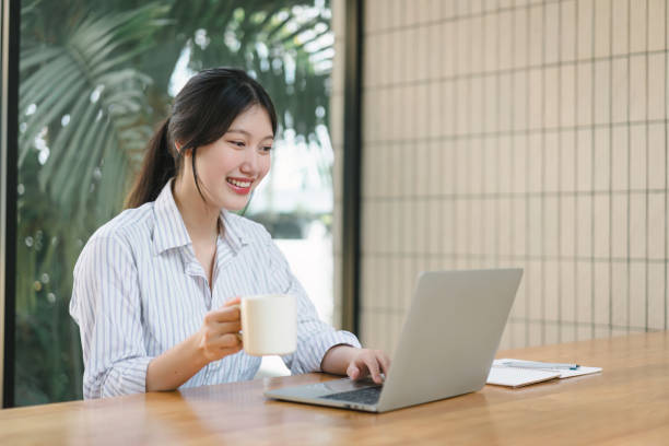 istock Smiling young asian businesswoman using laptop to work online, remote work. 1864644957