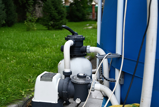 Sand filter system next to a pool in your own garden