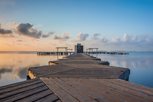 Wooden Jetty, reaching into the Mar Menor, in southern Spain, at sunrise. Long exposure to smooth out the sea