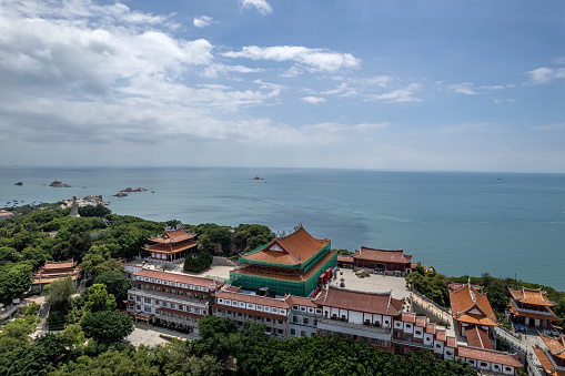 A bird's-eye view of the dense Chinese palace architectural complex on the island.\nArchitecture of Mazu Ancestral Temple Palace Complex on Meizhou Island, Putian City, Fujian Province, China
