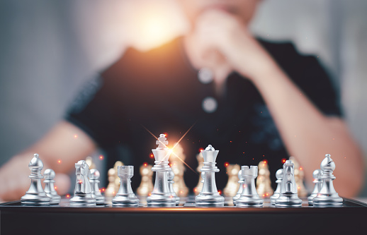 Confident Businessman Mastering Chessboard with Strategic Finesse. Success in Game of Business and Corporate Challenges. Man Focused Moves on the Chessboard. Navigating Challenges with Intelligence
